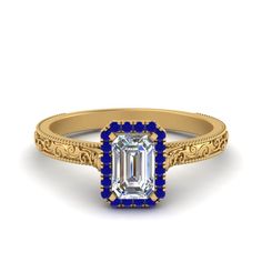 an emerald cut diamond ring with filigrees and blue accents on the band