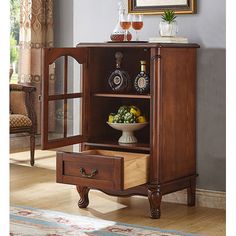 a wooden cabinet with two drawers and an open door on the front, in a living room