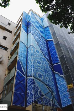 a tall building with blue tiles on it's side