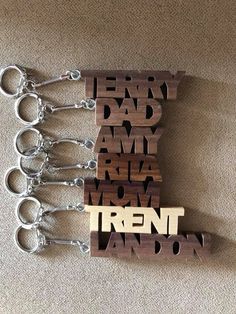 "Looking for a perfect personalized gift?  This hand scroll-sawed wooden keychain can be made with any name or word.   I first came up with the idea when our family all had their keychains hanging from the same key holder, and we would always get them mixed up.  Now, everyone knows whose is whose. Each name is made with your choice of 1/2\" thick maple or walnut wood, and is oiled to bring out the natural beauty of the wood.  Each name comes complete with a silver colored keychain. For names/wor Wood Laser Ideas, Wood Keychain, Wooden Keychain, Emoji Images, 3d Laser, Lasercut Design, Woodworking Wood, Wood Gifts, Holder Design