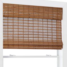 the bamboo blinds in this window are made out of wood and have white trims