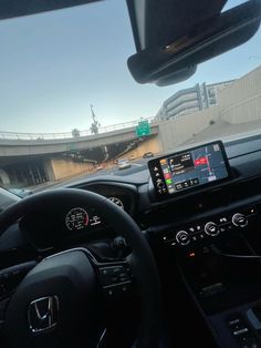 the dashboard of a car with an electronic device in it's center console, along with other vehicles