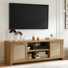 a flat screen tv mounted to the side of a wooden entertainment center