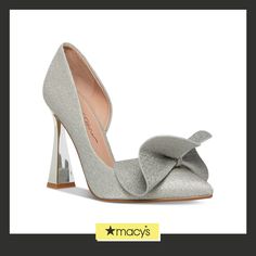 a pair of silver high heel shoes with a bow on the front and bottom part