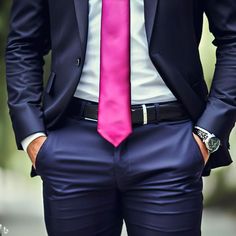 a man in a suit and pink tie