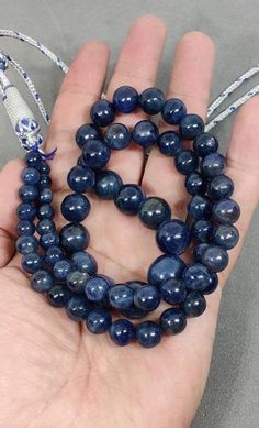 Untreated Natural Blue Sapphire  Smooth BeadsPrecious Blue Sapphire Tassel NecklaceSapphire Round Ball BeadSIZE - 6.5 mm to 12  mm Approx.Stone Type - Blue SapphireColor- BlueTreatment : Untreated LENGTH -24 inches Strand-1 StrandsPieces : 63 Pieces Weight-566 Carat Net WeightCode-NMML316Delivery time frames (from date of shipping)- USA: ~2 weeks- Rest of the World: ~ 3-4 weeksFor Express Shippinghttps://www.etsy.com/listing/656108132/express-shipping-5-to-7-business-days?ga_search_query=express Luxury Sapphire Gemstone Beads Necklace, Luxury Sapphire Gemstone Beads Necklaces, Luxury Sapphire Round Beads Jewelry, Blue Kyanite Round Bead Jewelry, Sodalite Gemstone Beads Necklaces, Blue Sodalite Round Beaded Jewelry, Sapphire Jewelry With 8mm Beads, Blue Round Gemstone Beads, Sapphire Necklaces With Polished Beads