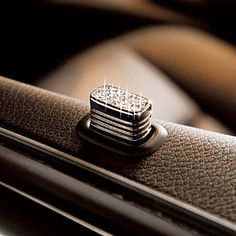 a diamond ring sitting on top of a leather seat in a car or truck,