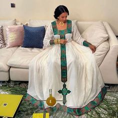 a woman sitting on top of a white couch