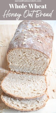 a loaf of whole wheat bread on a cutting board with oats scattered around it