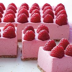 there are many small pieces of cake with raspberries on top