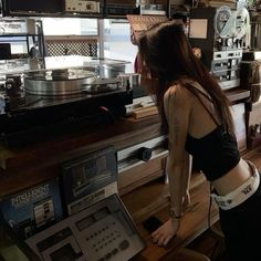 a woman standing in front of a record player