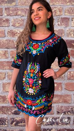 Cute Mexican Mini Dress with a detailed flower silk embroidery. Embroidery detail around sleeve, hem line and frontal floral design. With tie back for a perfect fit. Made of 100% cotton, manta (Musin) fabric. Embroidery color pattern may differ from one pictured. Match it with one of our Mexican Accessories: Espadrilles, Necklace, Shawl or Mexican Clutch. Perfect for any Mexican Themed party celebration. Look at our entire Dress Collection here. SIZE CHART: MEXICAN MINI DRESS WIDTH BUST LENGTH S Mexican Theme Party Outfit, Mexican Accessories, Mexican Boutique, Mexican Themed Party, Mexican Embroidery Designs, Mexican Quinceanera Dresses, Mexican Wedding Dress, Fiesta Dress, Pattern Outfits