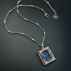 This book locket is created from circa 1930's original dies and tooling and a bezel set intaglio. An intaglio is a reverse cameo with an incised, etched image and is handmade, using the very same process used by Bohemian glass makers of the last centuries. Holds two photos. Chain: Hexagon figaro chain. Hand burnished silver finish .Locket: 1 x 7/8" Chain: 18" Last photo shows model for scale and other color, Designed and produced in our Los Angeles studio. Four colors available: Blue, Teal, Aqua Book Locket, Locket Bracelet, Figaro Chain, Bridal Bracelet, Amethyst Purple, Jewelry Repair, Blue Teal, Jewelry Companies, Girls Jewelry