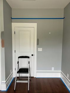 a chair sitting in front of a white door