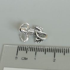 An open ended sterling silver gecko ear cuff/clip. Dimensions: 11.5 x 16mm Weight: 2gm Price listed is for ONE PIECE These are made of 925 hypoallergenic sterling silver. Most of my pieces come with a 925 stamp. Can be packaged in a gift box. I can include a personal message from you if needed You are welcome to contact me at... bhavnakwintra1956@gmail.com For more beautiful pieces from my shop, please browse 👇 TOE RINGS: https://www.etsy.com/your/shops/TheSilverGame/tools/listings/section:2702 Silver Clip-on Metal Cartilage Earrings, Silver Minimalist Clip-on Ear Cuff, Adjustable Silver Single Clip-on Earring, Unique Nickel-free Silver Piercings, Unique Adjustable Silver Ear Cuff, Silver Clip-on Cartilage Earrings As Gift, Adjustable Silver Clip-on Cartilage Earrings, Silver Clip-on Cartilage Earrings For Gift, Minimalist Adjustable Silver Clip-on Earrings