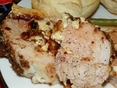 some meat and bread on a white plate