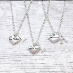 A lovely set of 3 sister necklaces perfect gift for Christmas or birthdays. Show your sisters how much you love them with these matching necklaces. Can also be personalised. These 3 chains come with big sister, middle sister and little sister charms. If you require just 'sister' please contact me. You can also order the necklaces with initials.  *the chains and findings are silver plated. The children chains are approximately 14inches or 16inches long and the adult chains measure approximately 18inches and 20inches long. They can be made longer or shorter on request. *the charms are all silver plated and measures approximately 1.5cm The necklaces come in gift bags but boxes are availablen for purchase from my store. If you have any questions or custom orders please feel free to contact me. Matching Sister Necklaces For 3 Sibling, Big Sister Present, Sister Necklaces, Sister Necklace Set, Boyfriend Initials, Big Sister Necklace, Middle Sister, Charmed Sisters, Big Sister Little Sister