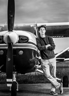 a man standing in front of an airplane