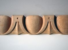 four wooden spoons lined up in a row