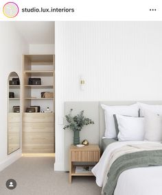 a bedroom with white walls and beige carpet