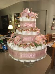 a three tiered diaper cake on top of a table