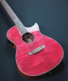 a red acoustic guitar on a black background