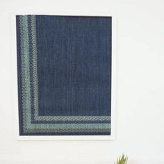 a potted plant sitting on top of a wooden table next to a blue rug