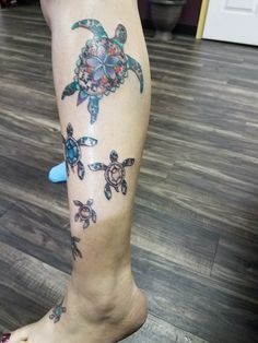 a woman's leg with tattoos on it and a turtle in the middle of her leg