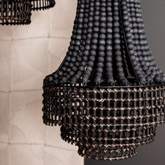 a chandelier hanging from the ceiling with black beads on it's sides