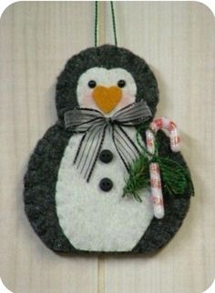 a felt penguin ornament hanging on a wall