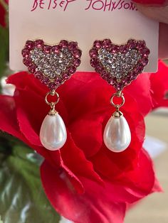 "Rhinestone hearts, Pearls. Betsey Johnson jewelry. Dangle earrings. So pretty. Betsey Johnson is an American fashion designer best known for her feminine and whimsical designs. Many of her designs are considered \"over the top\" and embellished." Pearl Heart, American Fashion Designers, Betsey Johnson Jewelry, American Fashion, Rhinestone Heart, Over The Top, Pearl Stud Earrings, Pearl Studs, Jewelry Earrings Studs