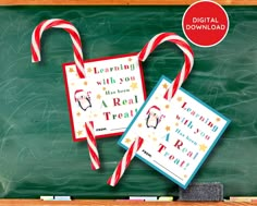 two candy canes are sitting next to each other on a chalkboard with the words learning with you