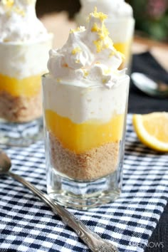 three desserts with lemon and meringue in small glass dishes on a table