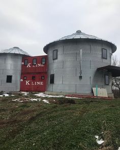 an old grain silo sits in the middle of a field with snow on the ground