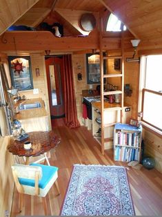 a living room filled with furniture and wooden walls