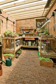 the inside of a greenhouse with lots of plants and potted plants in pots on shelves