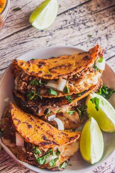 grilled fish with onions and cilantro on a white plate next to lime wedges