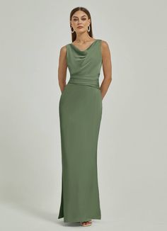 a woman in a long green dress standing with her hands on her hips and looking off to the side