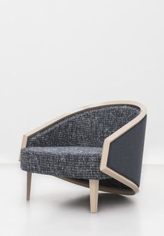 a chair that is made out of wood and grey fabric with a black seat cushion