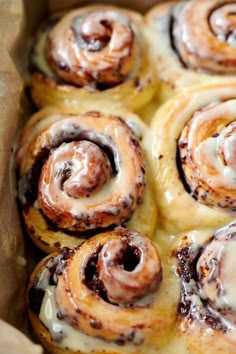 some cinnamon rolls are sitting in a box