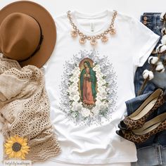 Elevate your style with our Our Lady of Guadalupe T-shirt - a blend of religious, fashion, and faith-inspired design. 🌹✨ Embrace the divine in our Virgin Mary Shirt, affectionately known as La Morenita Tee. Perfect for bohemian fashion lovers and an ideal Catholic gift, this religious tee celebrates love for culture and family traditions. Give the gift of faith and fashion - perfect for Mother's Day or any occasion. 🌟 #GuadalupeTshirt #VirginMaryShirt #BohemianClothing #CatholicGifts #Religiou Religious Fashion, Boho Mode, Our Lady Of Guadalupe, Bohemian Clothing, Lady Of Guadalupe, Mothers Day Gifts, Catholic Gifts, Bohemian Fashion, Bohemian Clothes