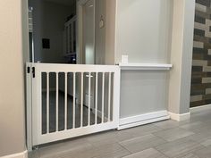 an empty room with white railings and wood flooring on the side walk way