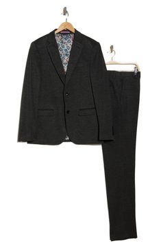 Clean lines and simple details yield a refined appearance in this elegant suit that's tailored in a slim fit. Jacket has front button closure; notched lapels; four-button cuffs; front flap pockets; chest welt pocket Lined 70% nylon, 24% polyester, 4% spandex, 2% other fibers
 Dry clean Imported Tailored Black Suit For Office Wear, Slim Fit Single Button Suits For Work, Slim Fit Single Button Suit, Slim Fit Single Button Suit For Workwear, Black Suits With Lapel Collar For Office, Black Suits With Welt Pockets For Work, Fall Single Button Three-piece Suit For Work, Black Single Button Suit For Workwear, Black Three-piece Suit With Hidden Buttons For Work