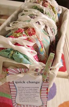 a basket filled with lots of cloths sitting on top of a table