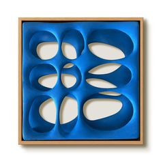 an abstract blue artwork piece in a wooden frame on a white background with cut outs