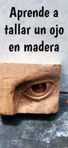 a wooden object with the words aprende a taller un ojo en madera