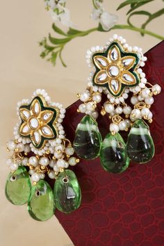 Product Features: Color: Green, Gold, White Base Material: Sterling Silver Plating: Gold-Plated Gemstones Used: Kundan, Pearls, Natural Stones, Faux Emerald Size: Freesize Dimension: Length of Earring= 5 CM; Width of Earring =3 CM; Adjustable - No Occasion: Casual Product Type: dangler Earring Disclaimer: There will be slight difference in digital to actual image Green Kundan Beaded Earrings, Earrings With Pearls, Dangler Earrings, Buy Earrings, Hand Bracelet, Kundan Earrings, Silver Work, Online Earrings, Craft Work