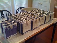 several boxes sitting on top of a table covered in wrapping paper and tied with twine