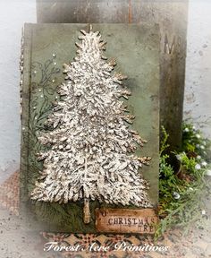 a card with a white christmas tree on it