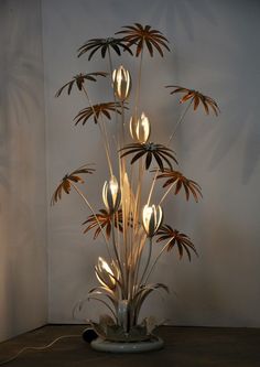 a lamp that is sitting on top of a table with flowers in the center and lights around it